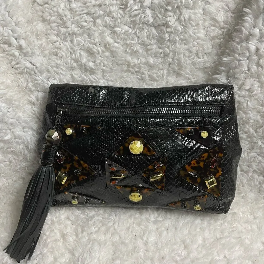 Rafe Black patent snake skin print clutch embellished with jewels and tassel .